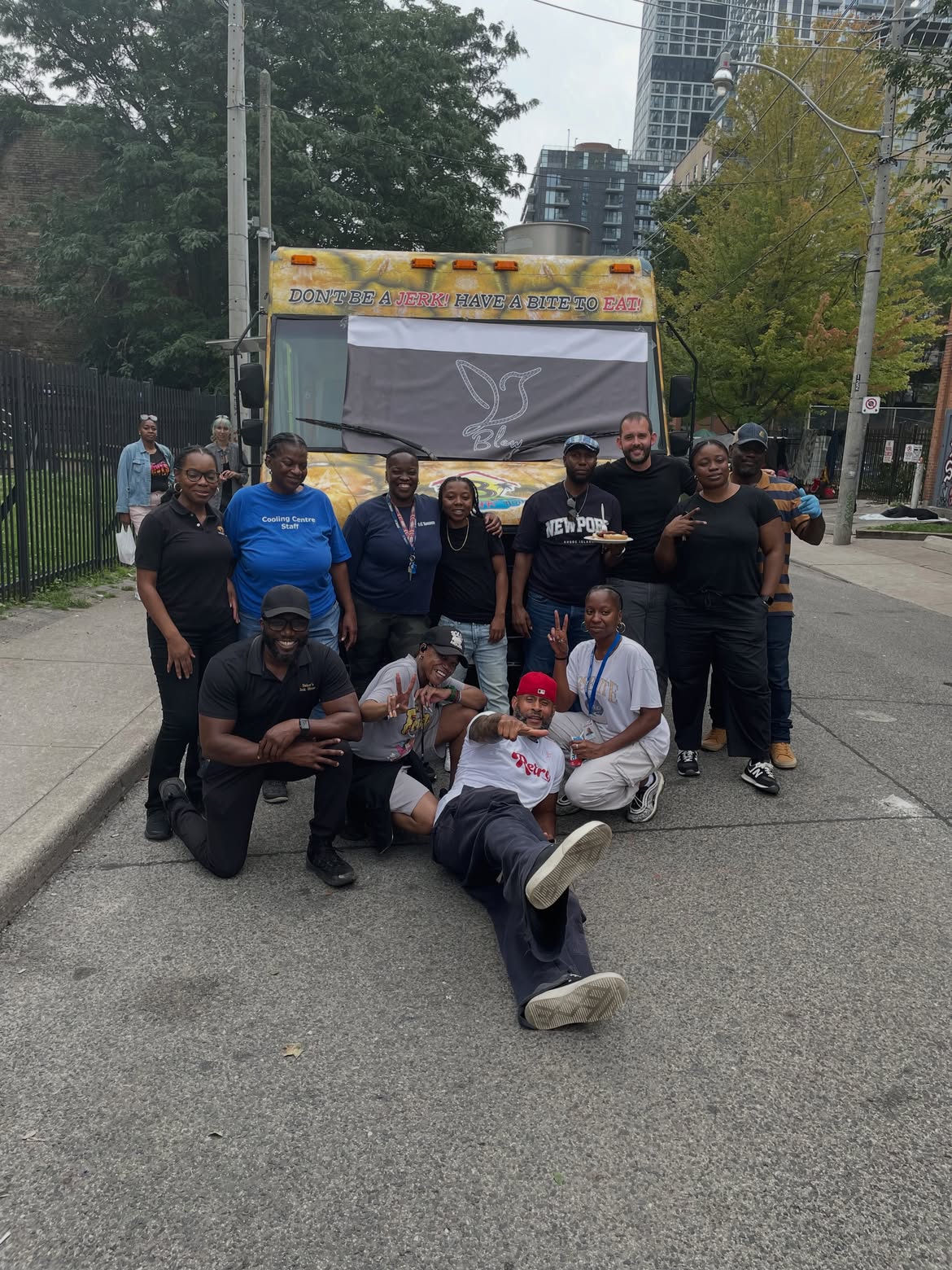 Community members and volunteers gathered in front of a food truck